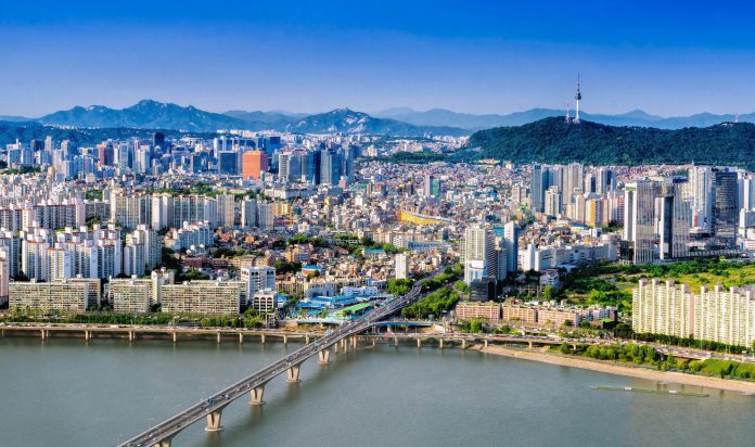 Aerial shot of Seoul City Skyline and N Seoul Tower with traffic bridge, South Korea.